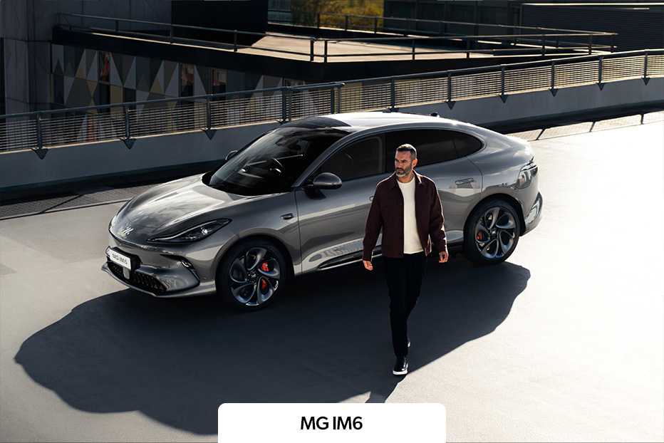 A silver MG IM6 parked as the driver walks away
